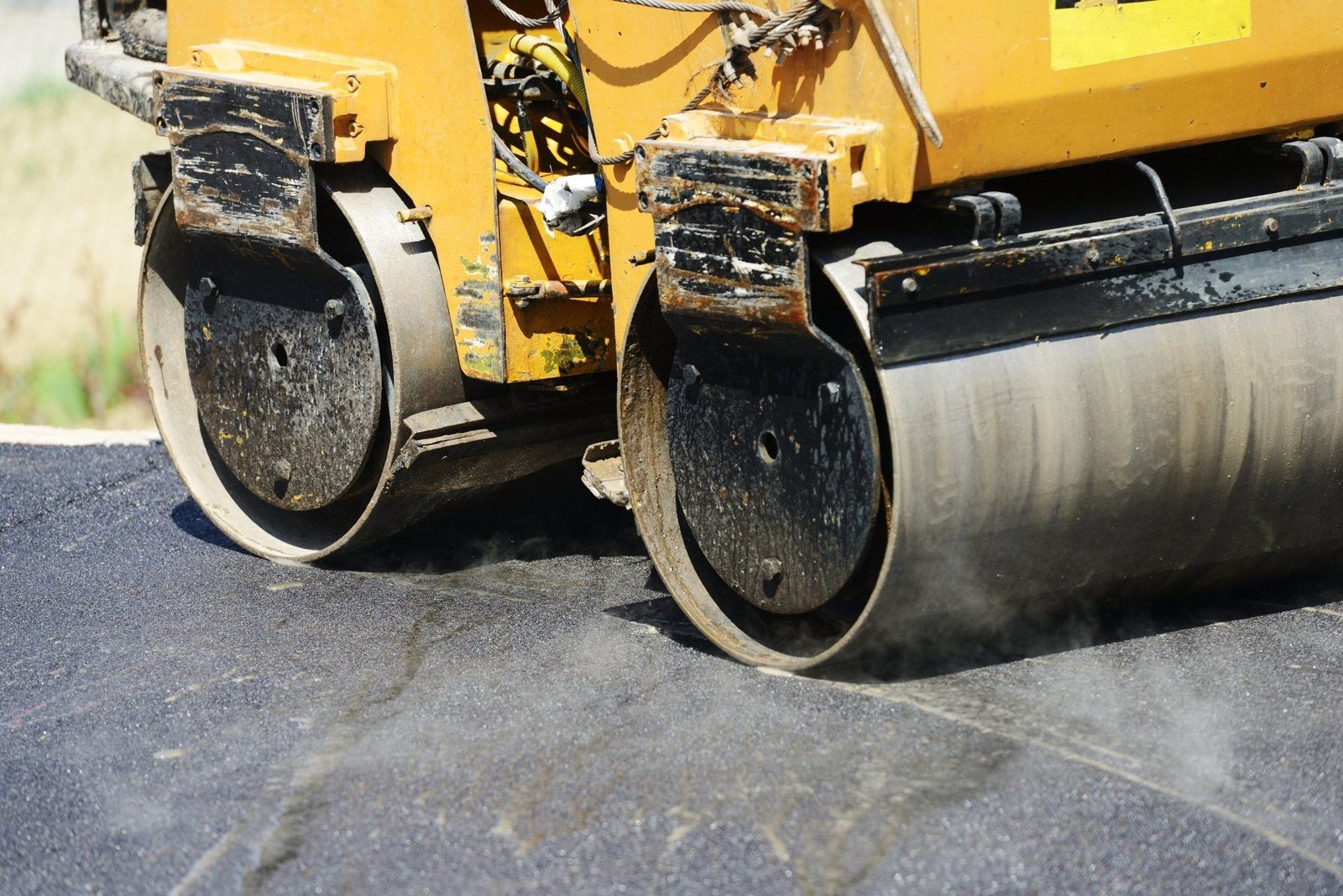 After patching potholes, this asphalt compactor is used to compress the asphalt surface.